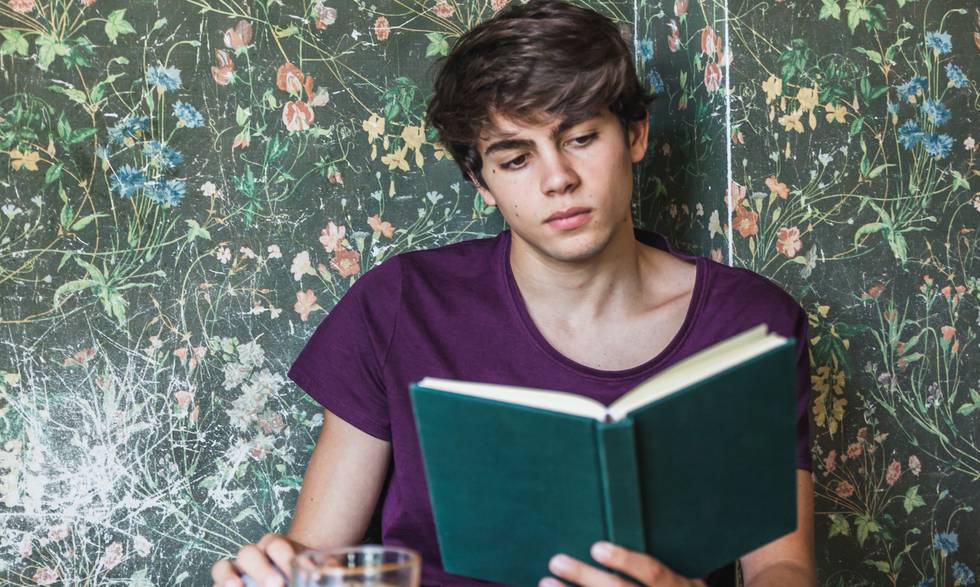 man-sitting-table-reading-book.jpg