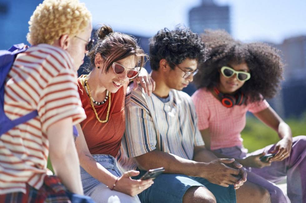 Young friends using smart phones